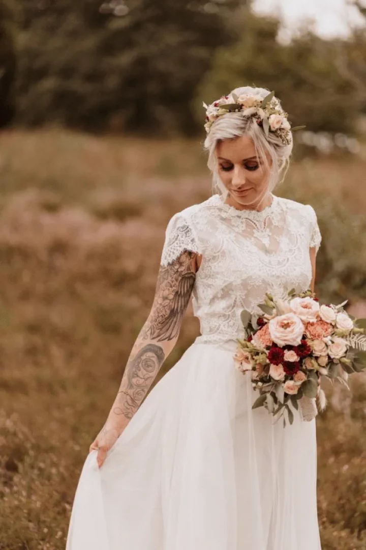 zweiteiliges brautkleid brautmode lüneburg hamburg zweiteiler junge Braut mit Blumenstrauß
