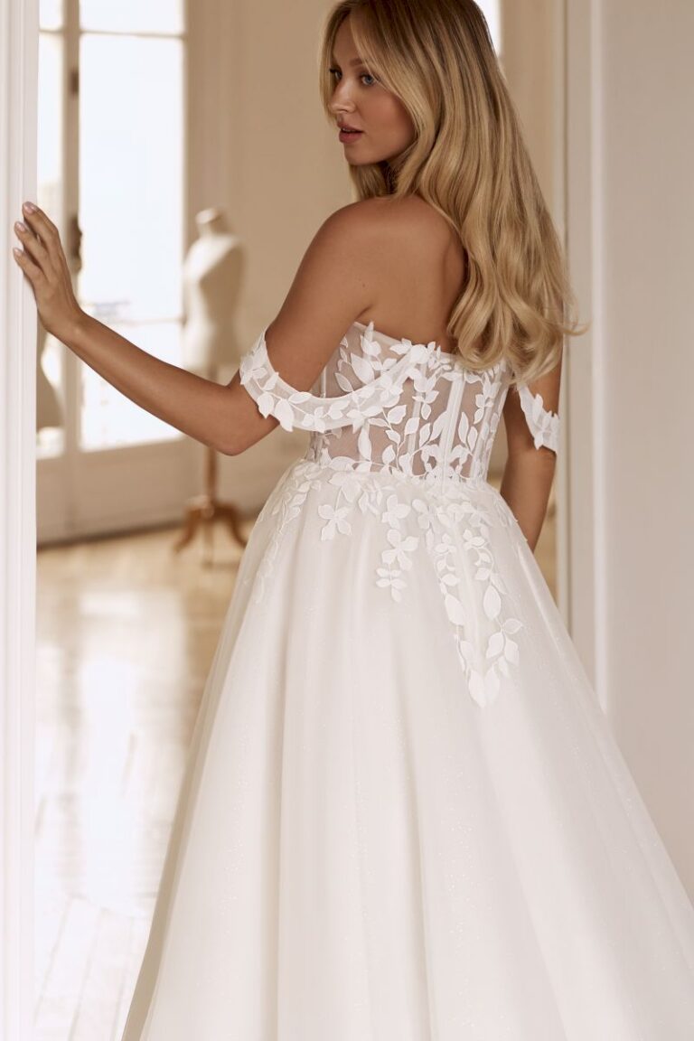 Romantisches Brautkleid NEITIRI von Anna Sposa mit schulterfreien Spitzenträgern, transparenter Korsage und Glitzertüll, Rückansicht, A-Linie, VeryNice Brautmode Winsen bei Hamburg